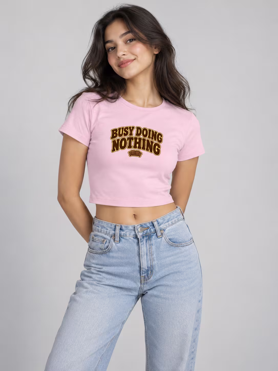 Busy Doing Nothing Baby Tee in Light Baby Pink, worn by a model