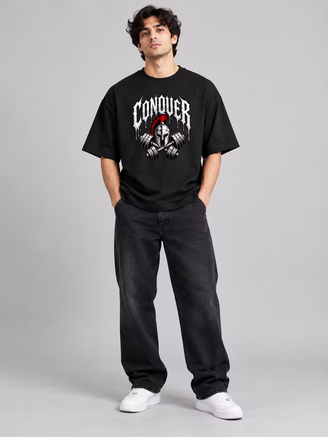 Gym t-shirt: Conquer Unisex Oversized T-Shirt in Black, worn by a model