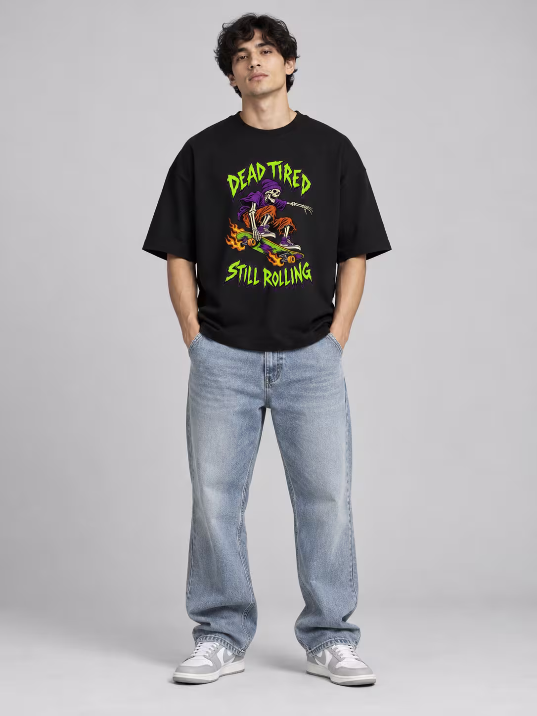 Dead Tired, Still Rolling Unisex Terry Oversized Tee in Black, worn by a model