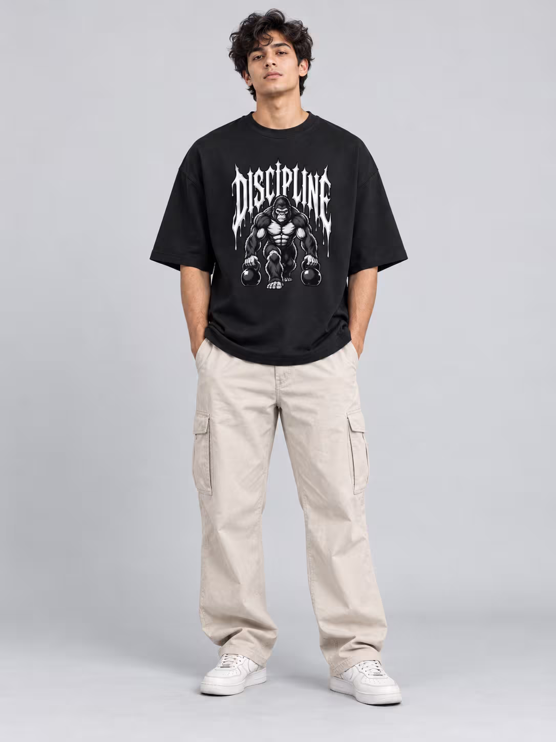 Gym t-shirt: Discipline Unisex Oversized T-Shirt in Black, worn by a model