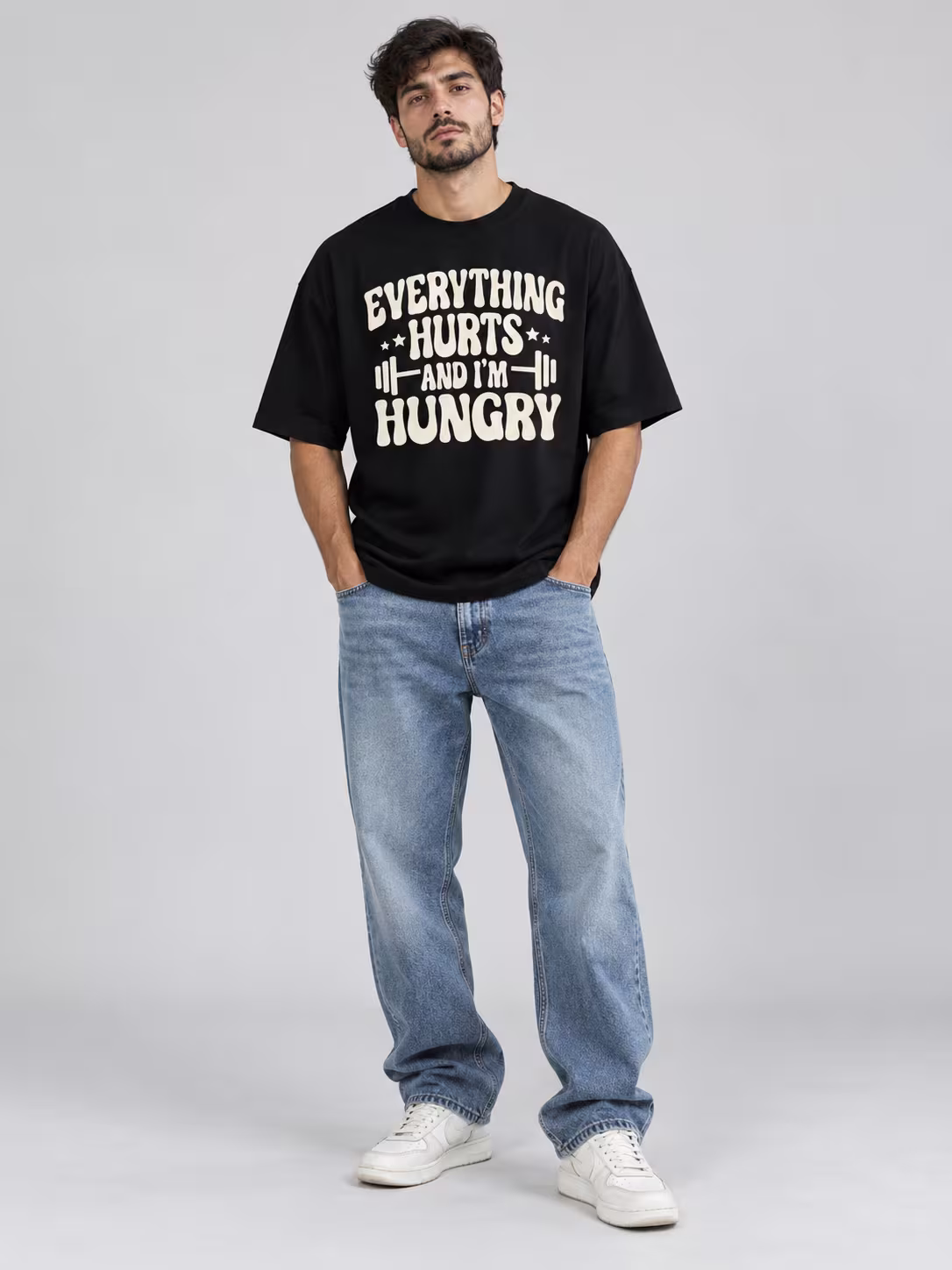 Everything Hurts Unisex Oversized T-Shirt in Black, worn by a model