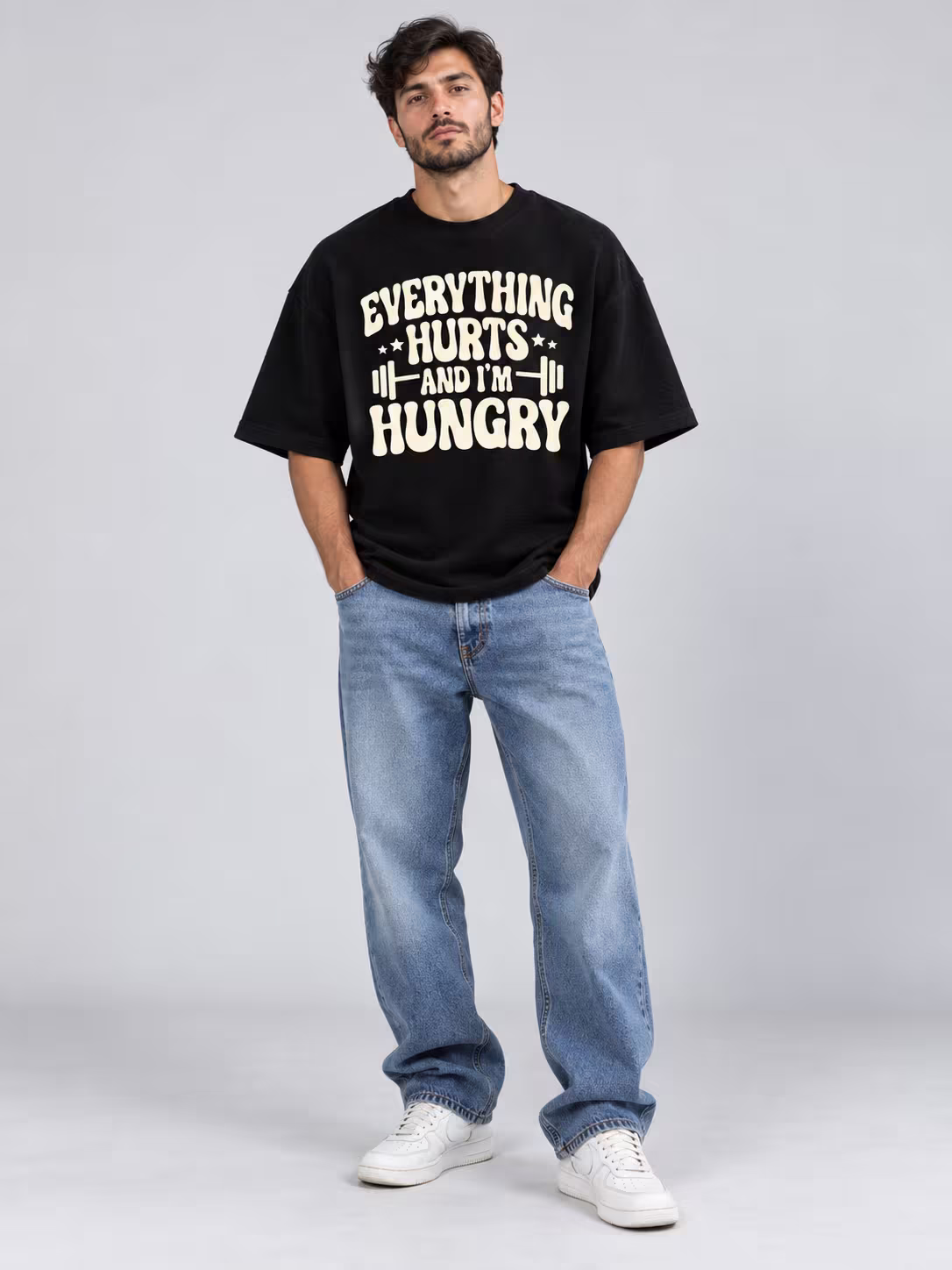Everything Hurts Unisex Terry Oversized Tee in Black, worn by a model
