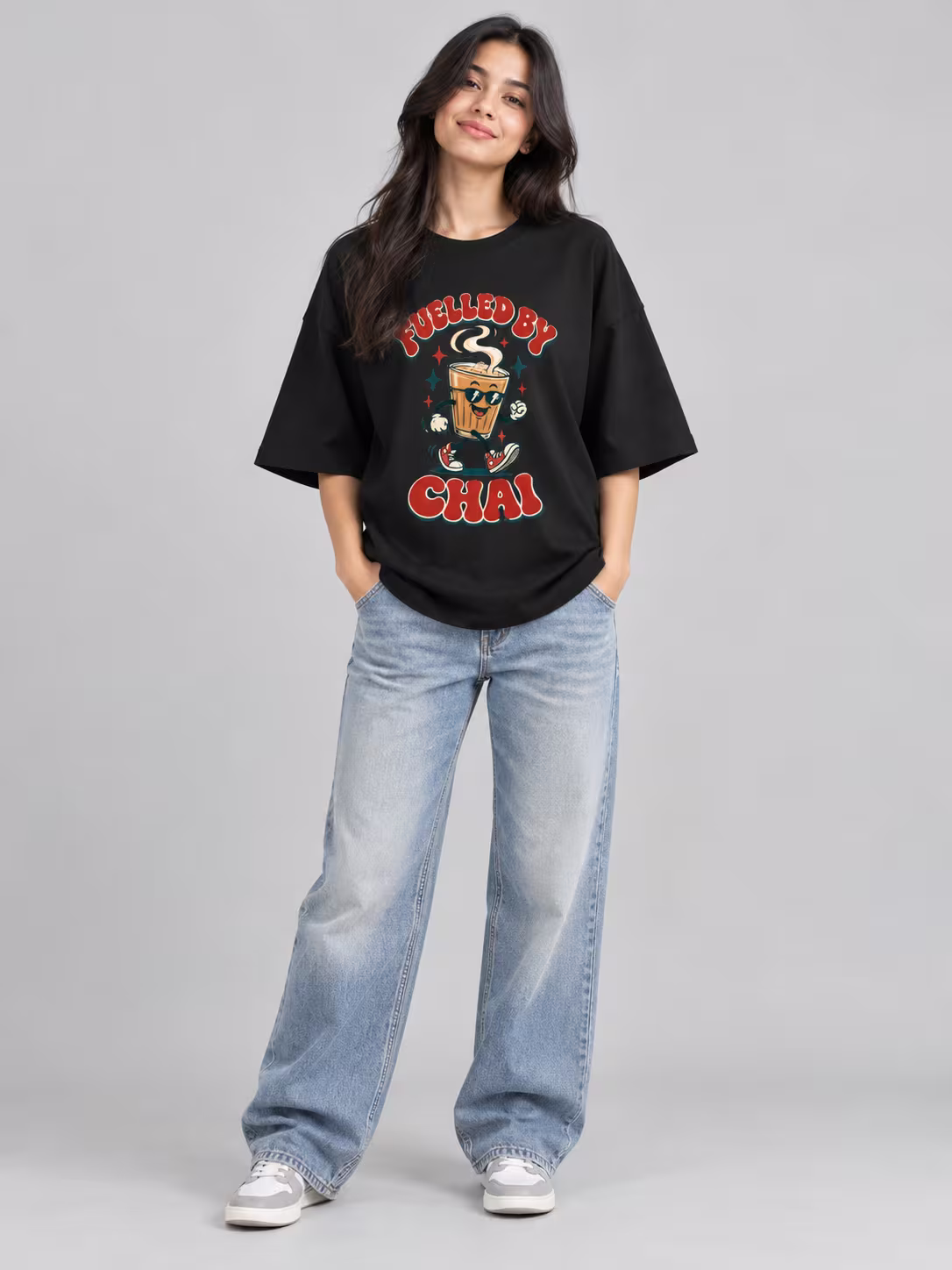 Fuelled By Chai Unisex Terry Oversized Tee in Black, worn by a model