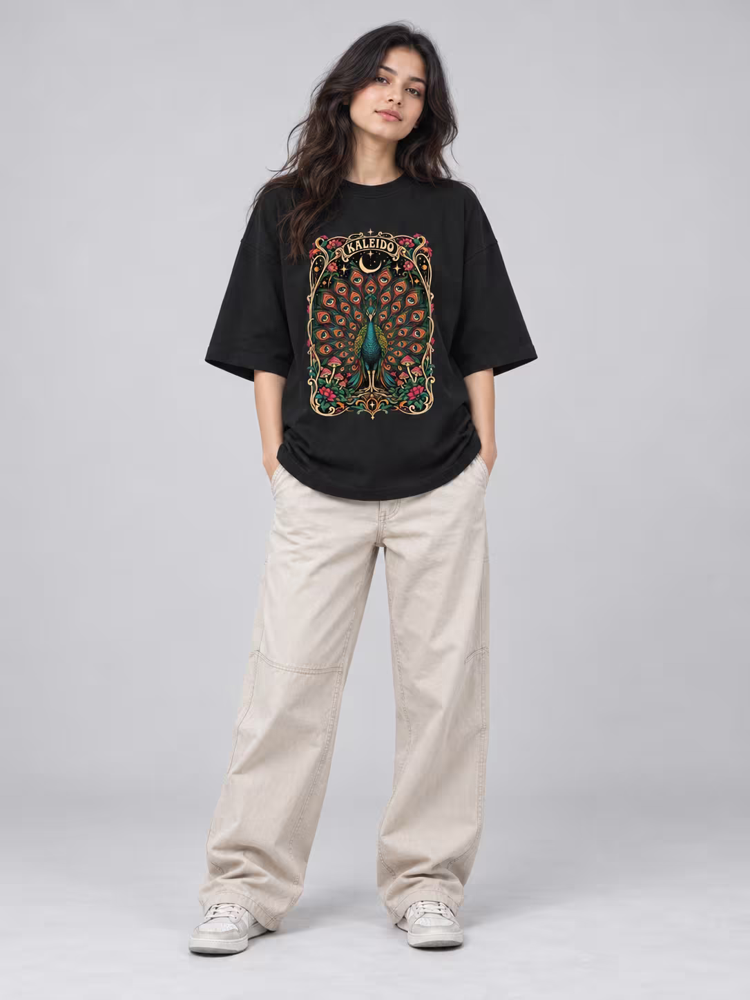 Kaleido Peacock Unisex Terry Oversized Tee in Black, worn by a model