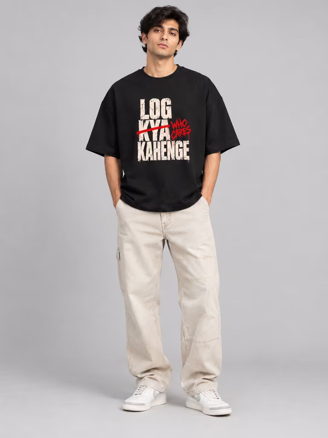Log Kya Kahenge Unisex Terry Oversized Tee in Black, worn by a model