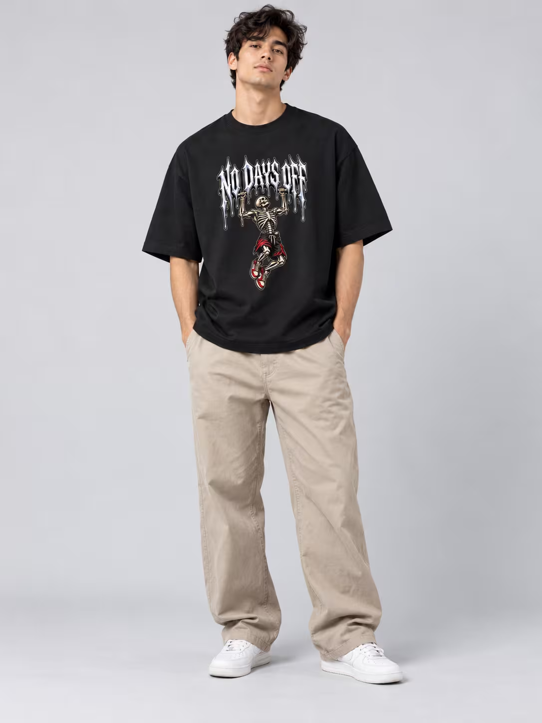 No Days Off Drip Unisex Oversized T-Shirt in Black, worn by a model
