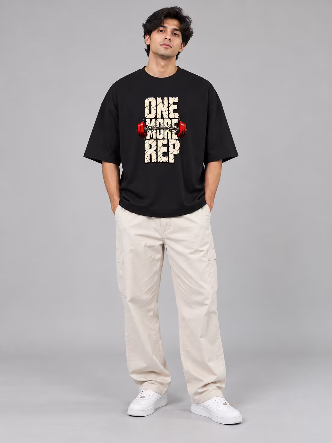 One More Rep Unisex Terry Oversized Tee in Black, worn by a model