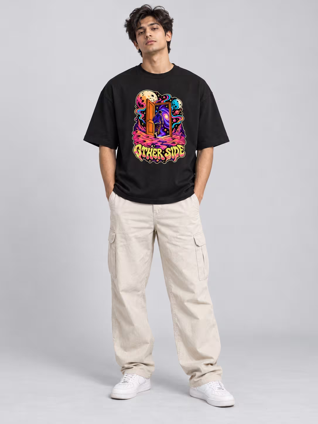 Other Side Unisex Oversized T-Shirt in Black, worn by a model