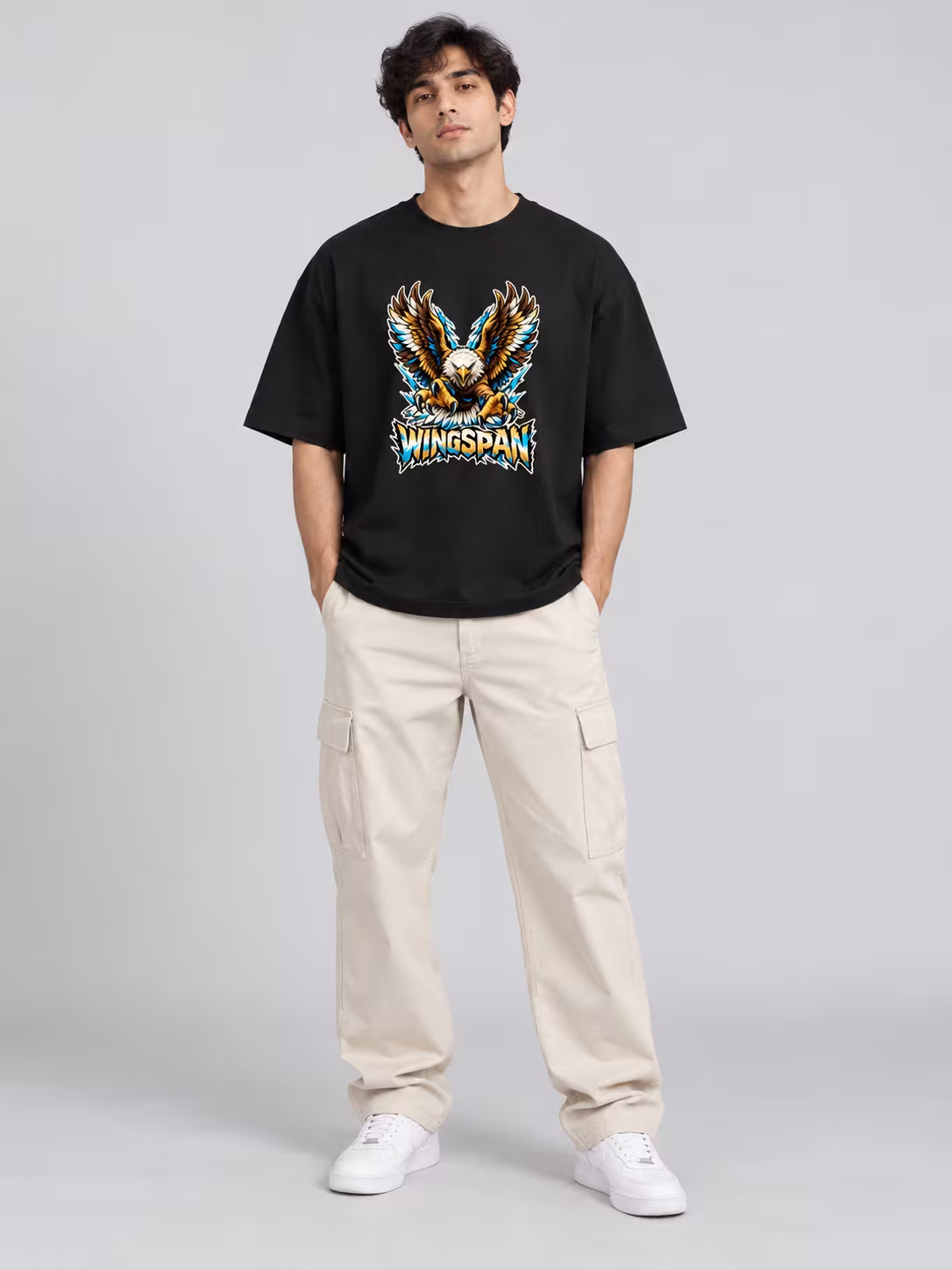 Wingspan Unisex Oversized T-Shirt in Black, worn by a model