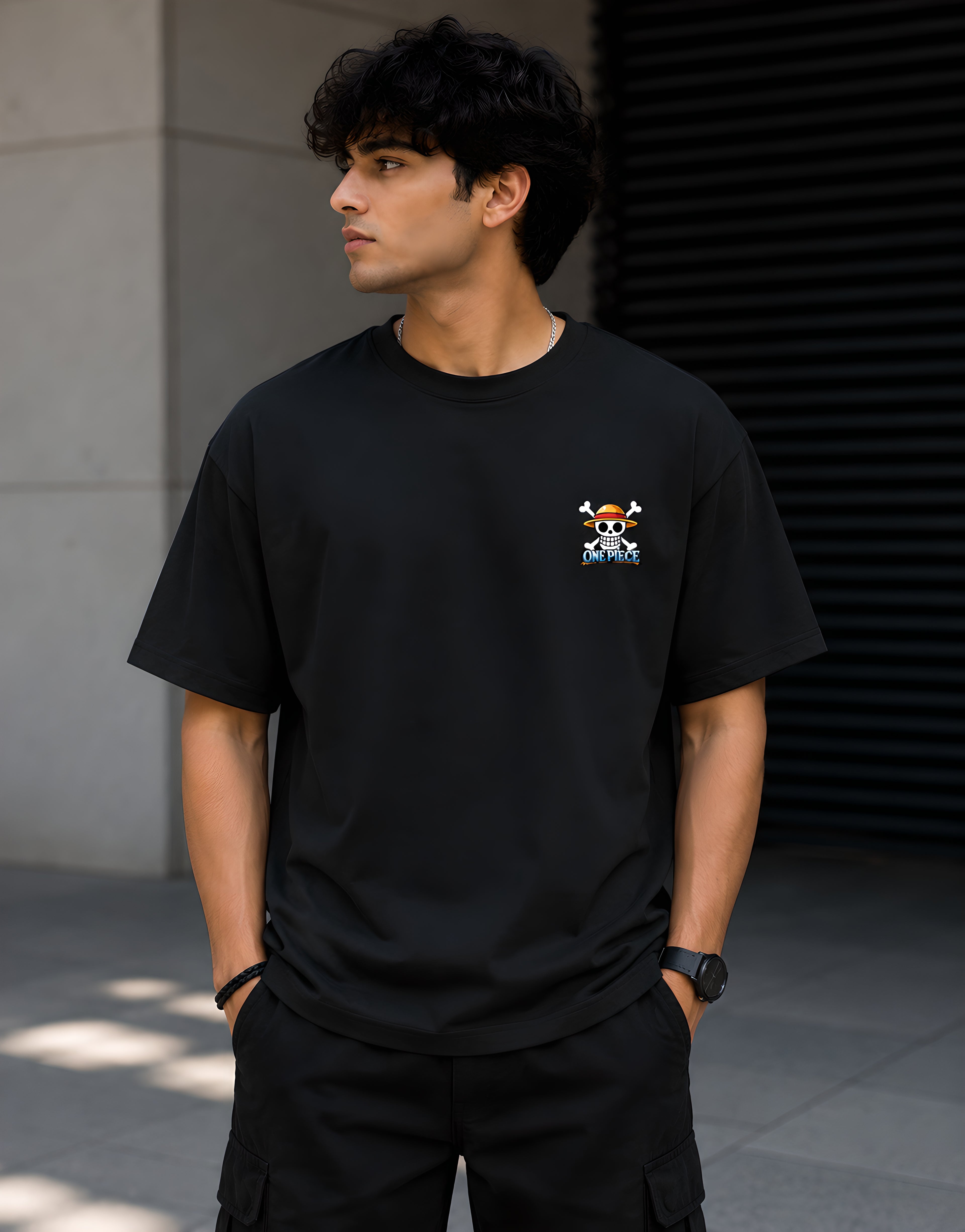 Front view of One Piece Gear 5 Luffy black anime t-shirt featuring Straw Hat Pirates skull logo on the left chest pocket print.
